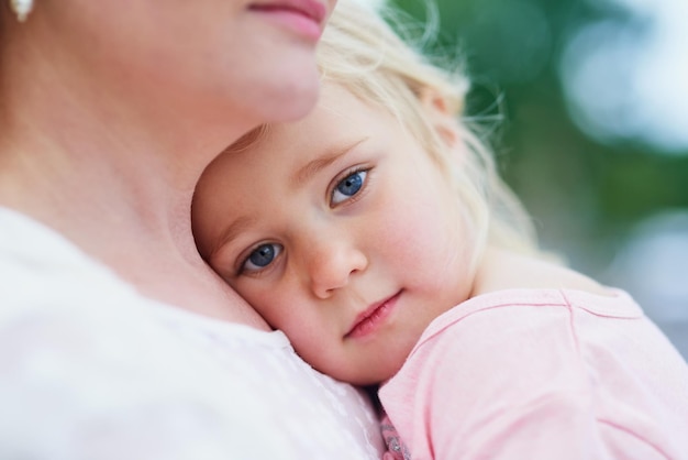 Im feeling blue Portait of a sad little girl being comforted by her mother outside