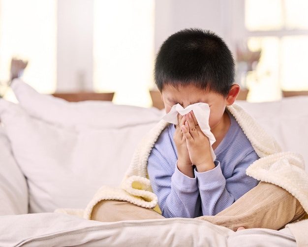 Im not feeling too good today Shot of a little boy feeling sick while sitting at home