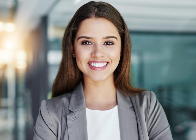 Im ready for corporate success Cropped portrait of an attractive young businesswoman standing in her office