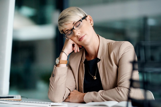 Im sure nobody will notice Shot of a young businesswoman sleeping at a desk in an office