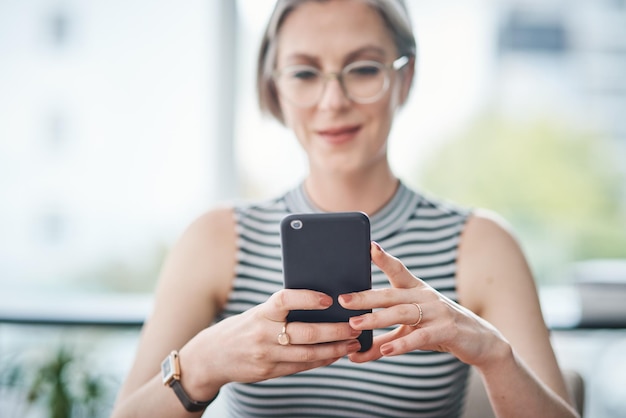 Im using the best tools to grow my business Cropped shot of a mature businesswoman using her cellphone in her office