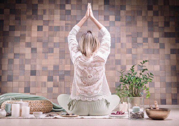 Image of an adult woman in yoga place. meditation. back view.\
the concept of yoga and spiritual practices. mixed media