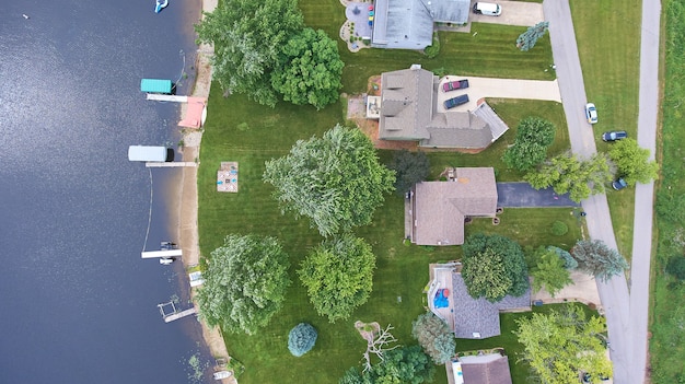 Image of Aerial of houses on lake with docks and boats