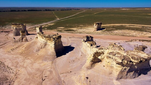 Image of Aerial view of desert road with pillars of white rock in unusual formations