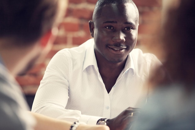 Image of AfricanAmerican business leader looking at camera in working environment