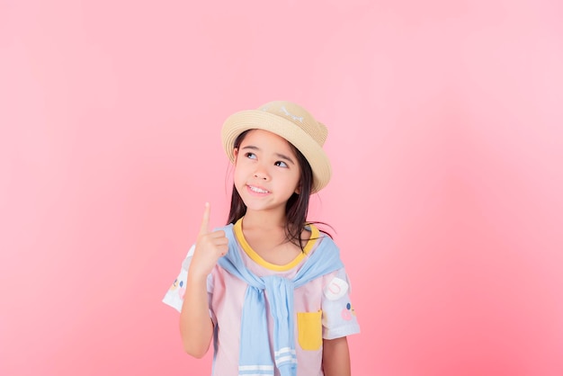 Изображение азиатского ребенка, позирующего на розовом фоне