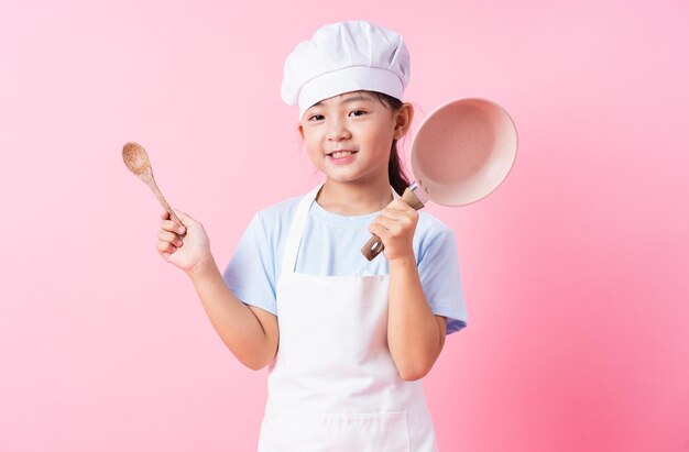 Image of Asian child practicing to be a chef