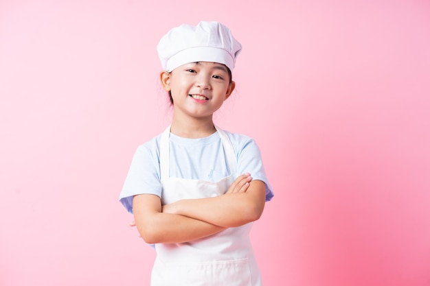 Image of Asian child practicing to be a chef