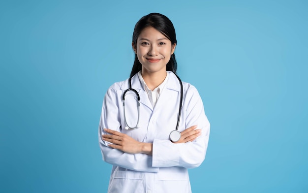 Photo image of asian female doctor posing on blue background