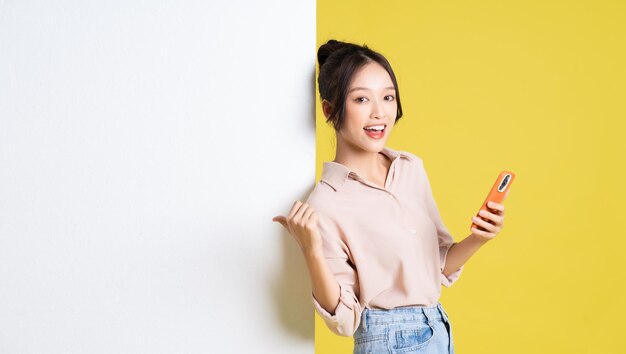 Photo image of asian girl standing and posing with billboard