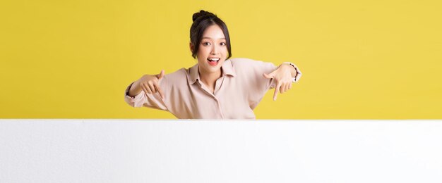 Photo image of asian girl standing and posing with billboard