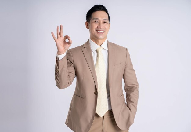 Image of asian male businessman posing on white background