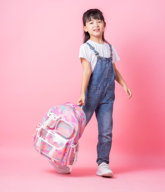 Image of Asian primary school student on pink background