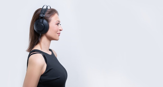 Image of an attractive woman with a headset. TV shopping concept. Mixed media