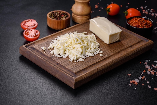 Image of a bar and grated mozzarella cheese on a dark background