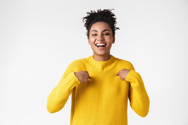 Image of a beautiful young african happy excited emotional woman posing over white wall.