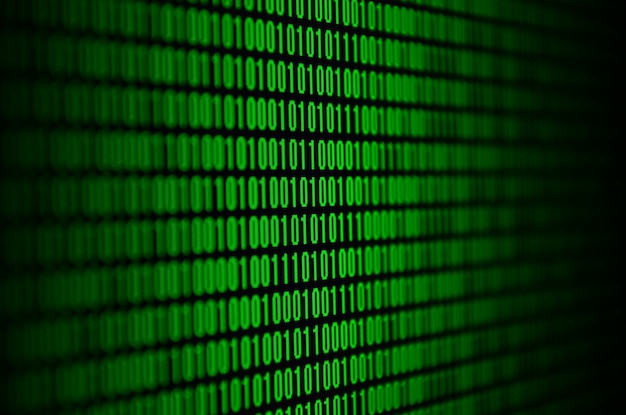 黒い背景に緑色の数字のセットで構成されたバイナリコードの画像