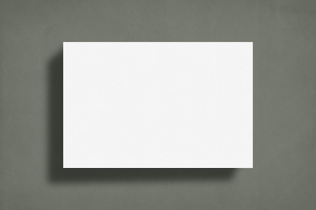 Photo image blank white poster on a grey wall