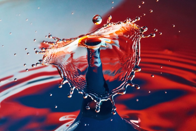 Photo image of blue and red water with umbrella mushroom of water