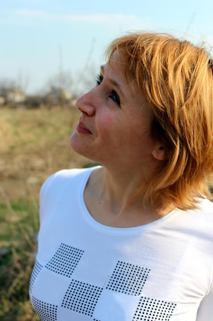 Image of blueeyed sympathetic girl looking at the sky