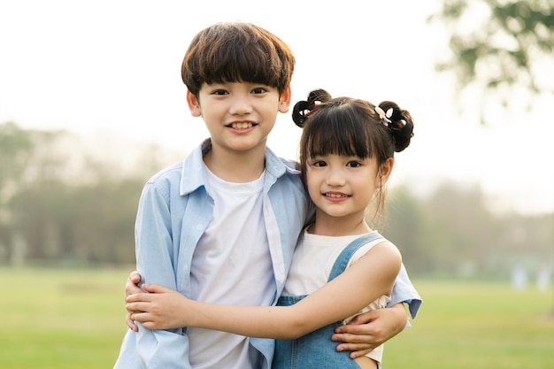 Image of brother and sister having fun in the park