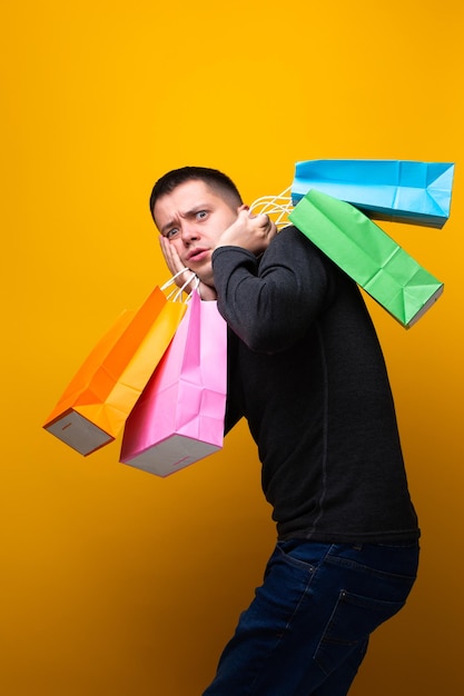 Image of brunet man with shopping bags