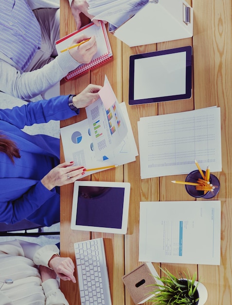 Image of business partners discussing documents and ideas at meeting