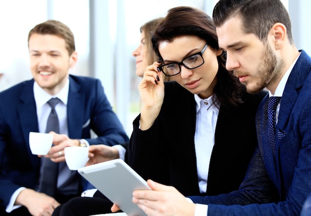 Image of business partners discussing documents and ideas at meeting