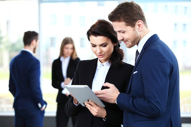 Photo image of business partners discussing documents and ideas at meeting