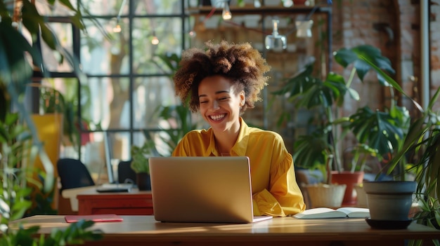 Image of cheerful african american woman using laptop while sitting on chair in living room