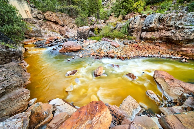 Image Of Clear And Brown Rivers Merging In Bend Of Canyon