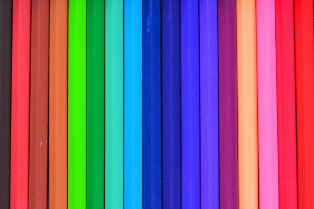 An image of Crayons. Colored Pencils. colored pencils on white background and wood chips