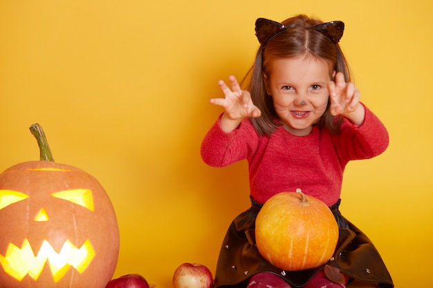 Image of cute little girl wearing red sweater and black skirt