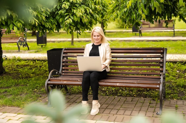 Image of elegant employer sitting on the bench.