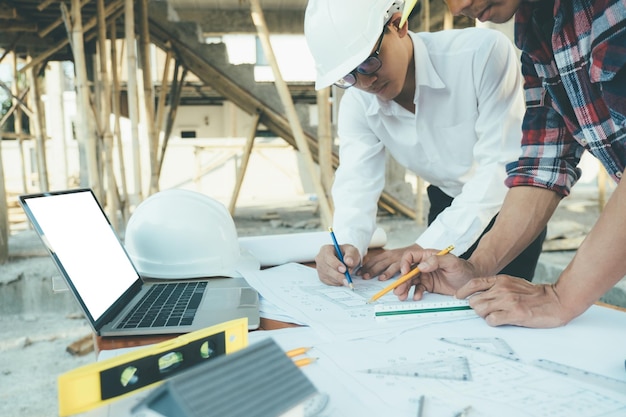 image of engineer meeting for architectural project working with partner and engineering tools on workplace