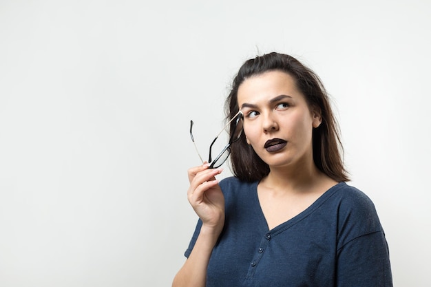 Image of excited young lady with glasses Looking camera have an idea Stands on a white background