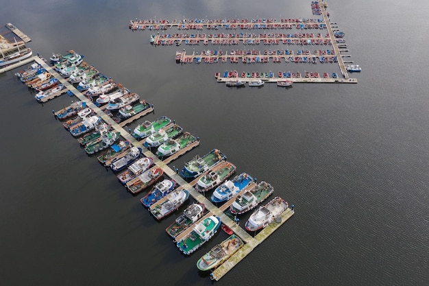 Image of fishing boats on the pier in the port aerial view