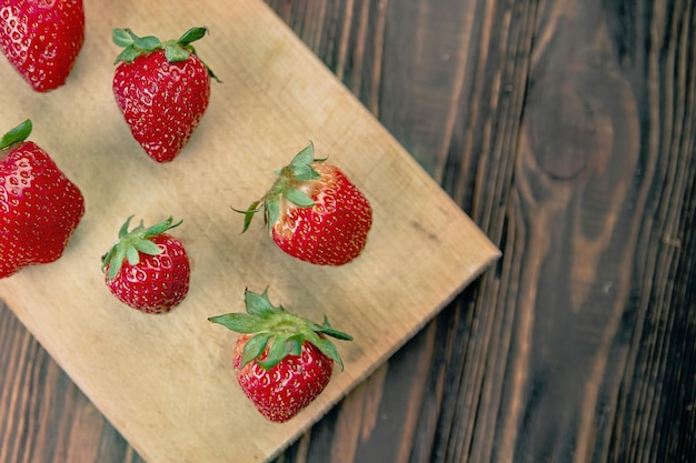 Image of fresh red strawberries on wooden board