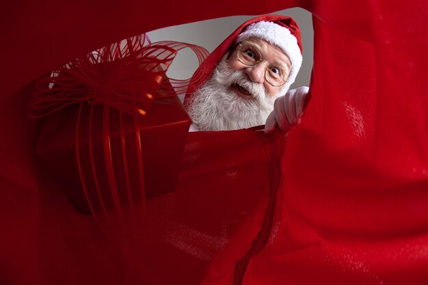 Photo image from inside the sack, santa claus putting gifts into the sack.