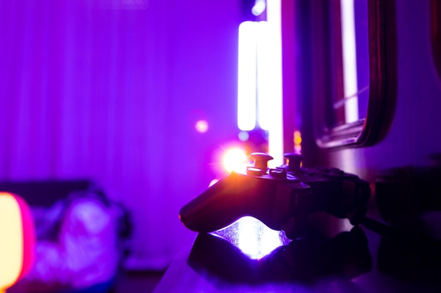 Image of a game controller controller in a room with gaming lights