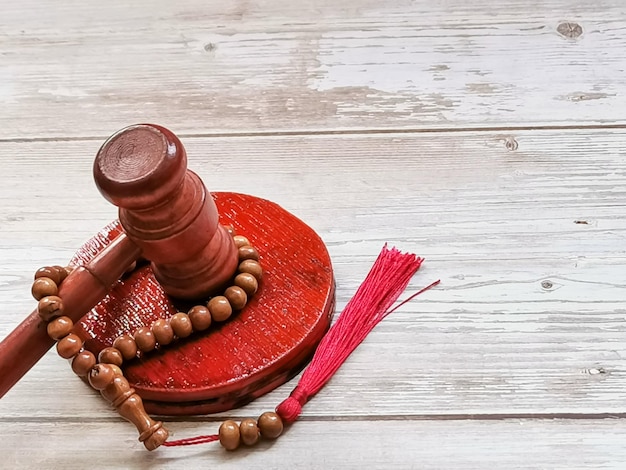 Image of gavel with prayer beads.