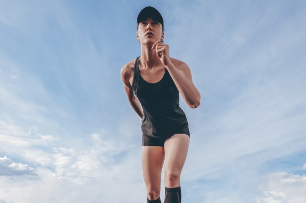 Image of a girl standing on the start line of the track. Running concept.