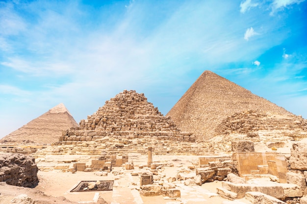 Image of the great pyramid of Giza. Cairo, Egypt. In the foreground is a and small pyramids of priests.