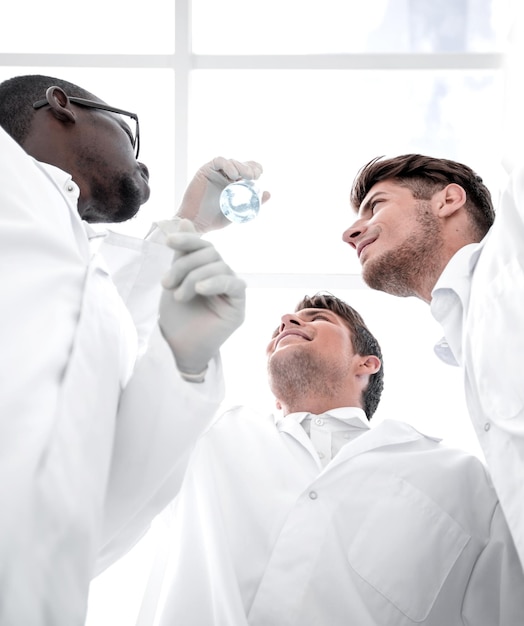 Image of a group of scientists looking at the results of their experimentscience and health