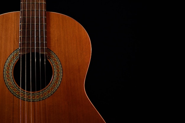 Image of a guitar on a black background to use as an advertising banner or desktop background