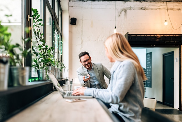 Image of a guy asking a girl for her phone number at the cafe.