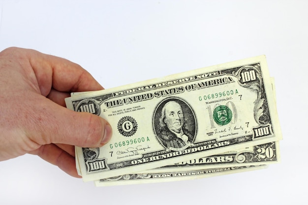 Image of hand holding US dollars isolated on a white background