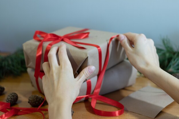 Photo image of the hands that make handmade gifts for christmas. high quality photo