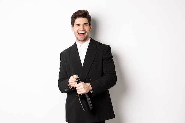 Image of handsome, confident man in black suit