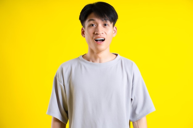 Image of handsome young man posing on a yellow background